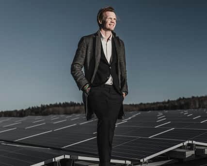 A Castellum sign against a green wall.